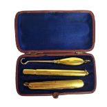 A 19TH CENTURY CONTINENTAL YELLOW METAL CHATELAINE SET Comprising a pencil case, penknife and button