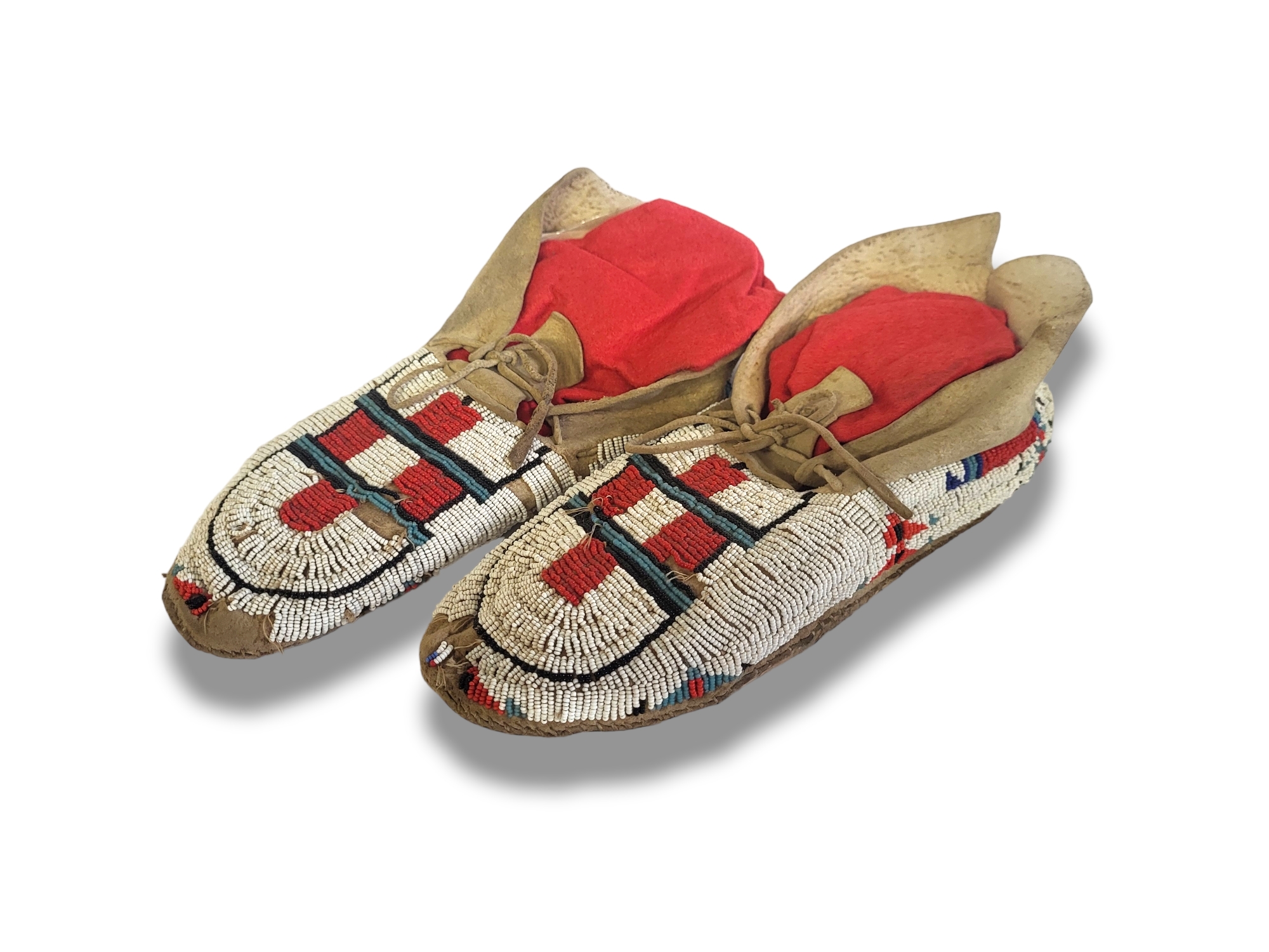 A PAIR OF ANTIQUE NATIVE AMERICAN INDIAN ANIMAL SKIN AND BEADWORK MOCCASINS Having red white and