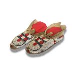 A PAIR OF ANTIQUE NATIVE AMERICAN INDIAN ANIMAL SKIN AND BEADWORK MOCCASINS Having red white and