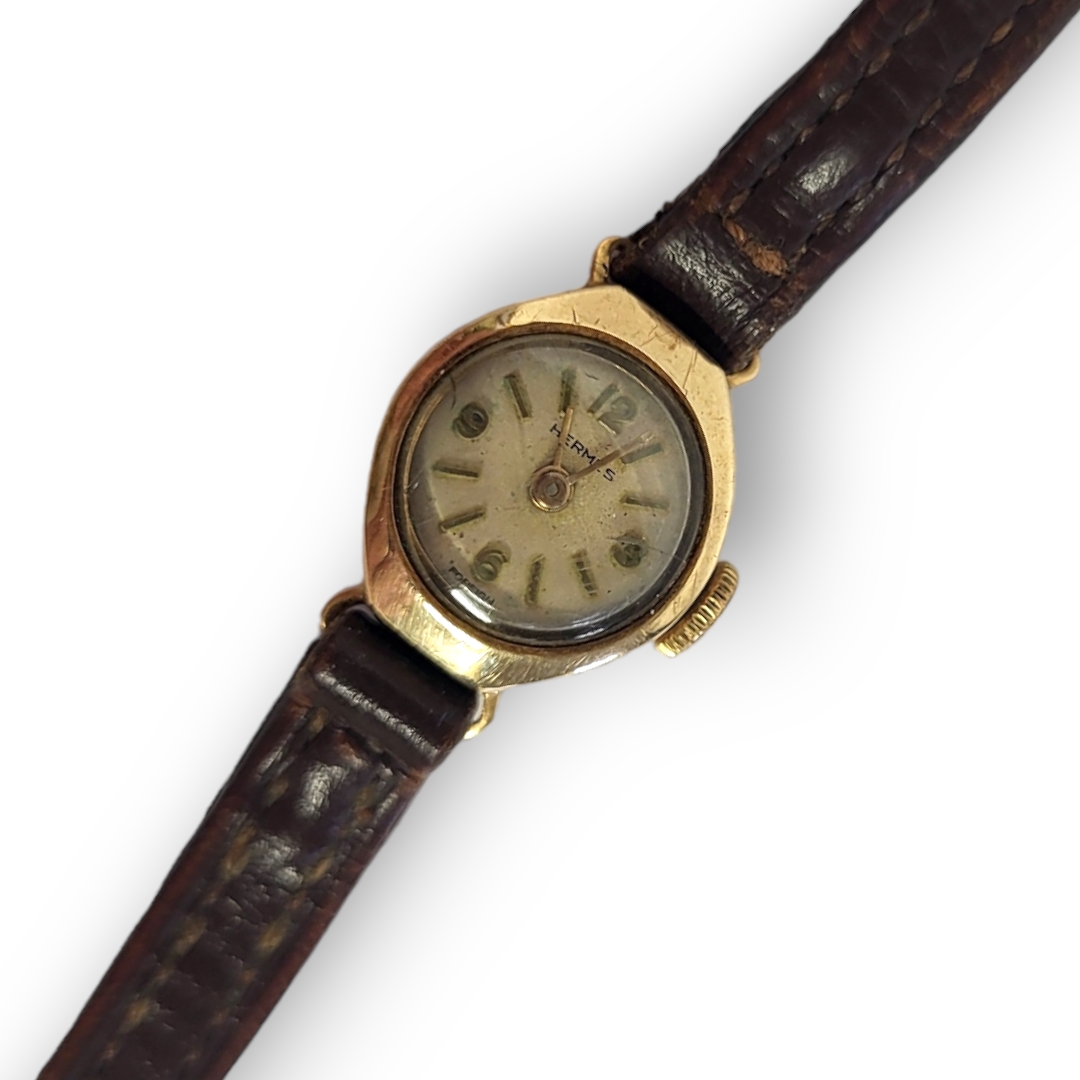 HERMÈS, A VINTAGE 9CT GOLD LADIES’ WRISTWATCH Having a lozenge form case and circular white dial, on - Image 2 of 2