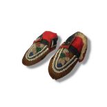 A PAIR OF ANTIQUE NATIVE AMERICAN INDIAN ANIMAL SKIN AND BEADWORK CHILD'S MOCCASINS Having an