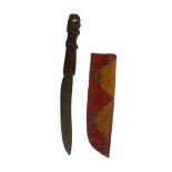 A 19TH CENTURY TRIBAL KNIFE The figural carved wooden with mother of pearl eyes, slightly carved