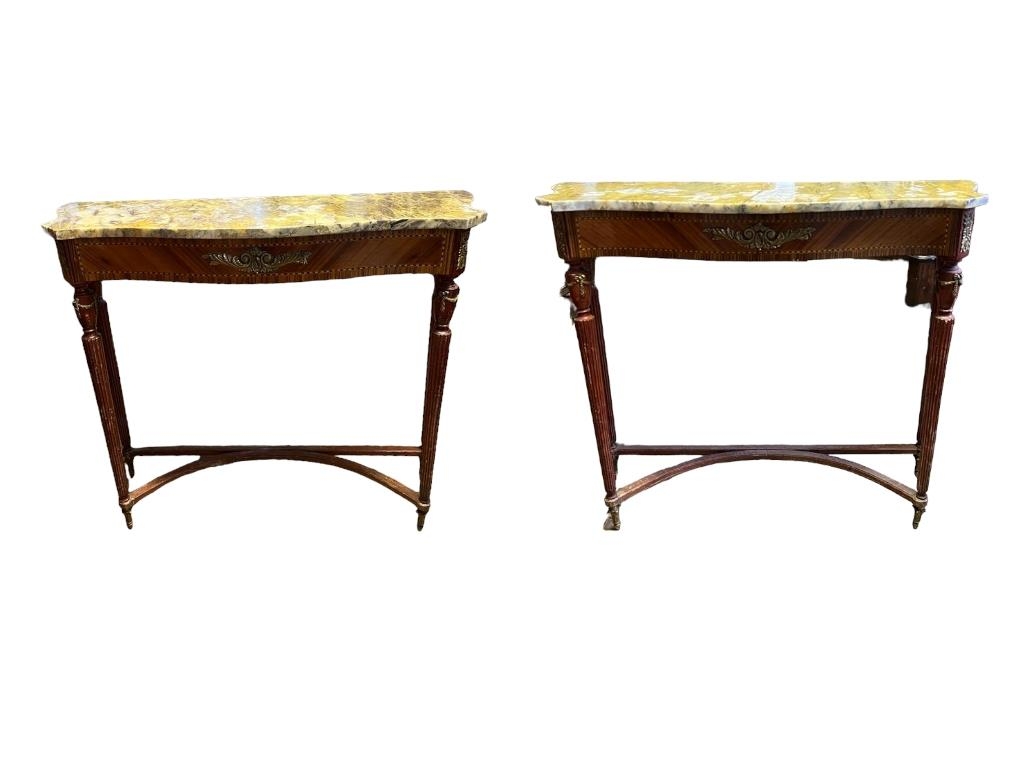 A PAIR OF MID 20TH CENTURY ITALIAN MAHOGANY CONSOLE TABLES The serpentine marble tops on fluted