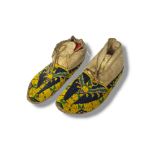 A PAIR OF ANTIQUE NATIVE AMERICAN INDIAN ANIMAL SKIN AND BEADWORK MOCCASINS Having yellow blue and