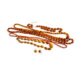A COLLECTION OF FOUR VICTORIAN BUTTERSCOTCH AMBER NECKLACES,two having uniform oval beads and two