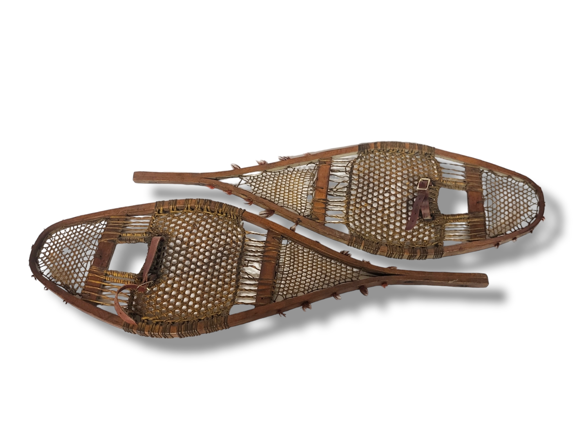 A PAIR OF ANTIQUE NATIVE AMERICAN INDIAN OVAL WOODEN SNOWSHOES With pierced wicker trellis and