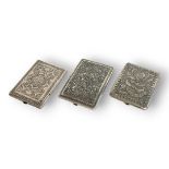 THREE LATE 19TH CENTURY PERSIAN WHITE METAL/SILVER GENTLEMAN'S CIGARETTE CASES Each embossed with