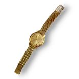 OMEGA, AN 18CT GOLD GENT’S WRISTWATCH Circular gold tone dial and slim case on a 9ct gold bracelet