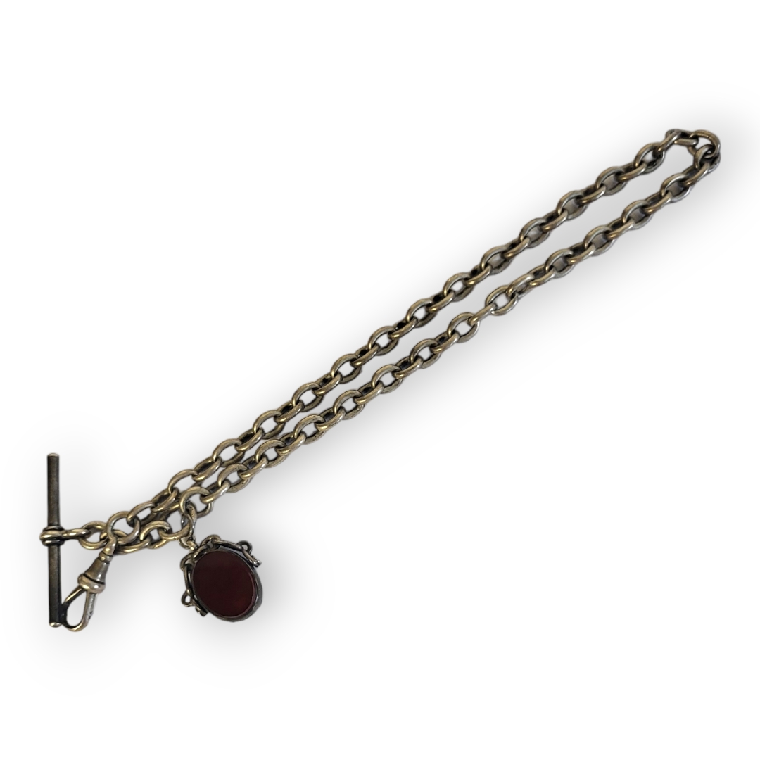 A VICTORIAN SILVER ALBERT CHAIN Having uniform pierced links and hardstone swivel fob. (approx 37cm)