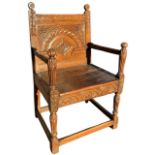 AN UNUSUAL 17TH CENTURY ENGLISH CARVED OAK WAINSCOT ARMCHAIR The carved panel back above plank