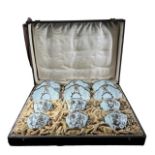 UTZSCHNEIDER & CIE, FRENCH, A LATE 19TH CENTURY CASED SET OF SIX PORCELAIN AND APPLIED SILVER COFFEE