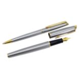 A VINTAGE WATERMAN PARIS HEMISPHERE FOUNTAIN PEN AND BALLPOINT PEN 23ct gold plated and steel. (
