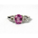 AN 18CT WHITE GOLD, OVAL PINK SAPPHIRE AND DIAMOND THREE STONE RING. (Approx Pink sapphire 1.50ct,