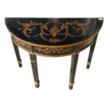 A DECORATIVE EBONISED REGENCY DESIGN DEMILUNE SIDE TABLE Painted with scrolling foliage and flowers.