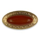 A LARGE VICTORIAN YELLOW METAL AND AMBER OVAL BROOCH (TESTED AS 9CT) Having chased and engraved