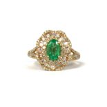 A 14CT YELLOW GOLD CLUSTER RING, with central oval emerald surrounded by baguette cut diamonds and