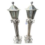 A PAIR OF STYLISH SILVER PLATED FLOORSTANDING LANTERN LAMPS With scrolling decoration. (h 150cm)