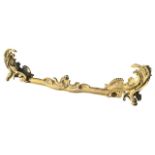 A 19TH CENTURY FRENCH ROCOCO GILT ORMOLU CHENET WITH SCROLLING FOLIAGE AND SHELL DECORATION. (w