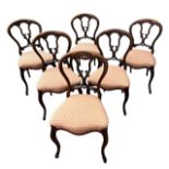 A SET OF SIX 19TH CENTURY VICTORIAN ROSEWOOD BALLOON BACK DINING CHAIRS The pierced backs above a