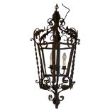 A LARGE DECORATIVE 19TH CENTURY VICTORIAN DESIGN SCROLLING IRON HALL LANTERN With leaf