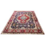 A LARGE PERSIAN RED GROUND CARPET With stylised floral geometrical pattern. (345cm x 250cm)