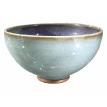 A CHINESE JUN GLAZED BOWL HAVING ROUNDED SLIDES RISING TO A SLIGHTLY INCURVED RIM Sky blue and