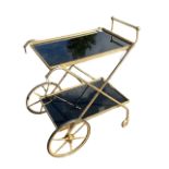 A 20TH CENTURY FRENCH TWO TIER GILT METAL AND BLACK GLASS DRINKS TROLLEY. (h 72.5cm x d 49cm x w