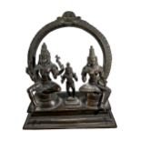 A 19TH CENTURY INDIAN BRONZE FIGURAL GROUP OF SOMASKANDA Showing Shiva and Pravati. (h 21cm x w 17.