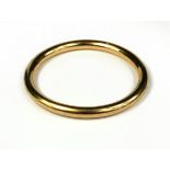A 9CT GOLD HOLLOW BANGLE Having a hidden pinch clasp, marked ‘AWR’ to clasp. (outer diameter 77mm,