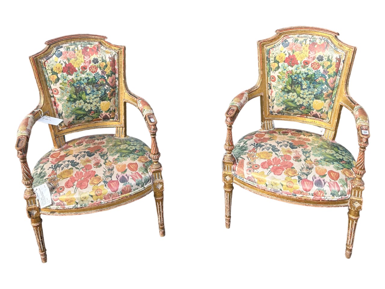 A PAIR OF FRENCH LOUIS XVI DESIGN CARVED GILTWOOD ARMCHAIRS The shaped back above padded arms with