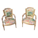 A PAIR OF FRENCH LOUIS XVI DESIGN CARVED GILTWOOD ARMCHAIRS The shaped back above padded arms with