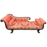 A 19TH CENTURY REGENCY MAHOGANY DAYBED With scrolling arms and back, raised on saber legs