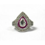 AN 18CT WHITE GOLD PEAR SHAPED ROSE CUT DIAMOND RING set with calibre cut rubies and round brilliant