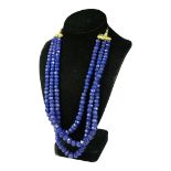 A BLUE ONYX NECKLACE, with adjustable slip knot and patterned cord.