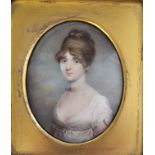 A 19TH CENTURY OVAL MINIATURE PAINTING ON IVORY, PORTRAIT OF A YOUNG LADY IN A CREAM SILK DRESS
