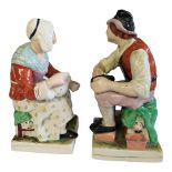 STAFFORDSHIRE, A PAIR OF FIGURES BY KENT MODELLED AS THE COBBLER AND HIS WIFE Raised on square