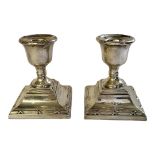 A PAIR OF SMALL HALLMARKED SILVER TOP DESK CANDLESTICKS Birmingham, 1929, of Neoclassical shape,