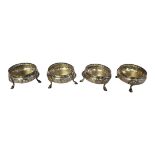A SET OF FOUR VICTORIAN SILVER CIRCULAR SALTS With gadrooned border and embossed decoration, on