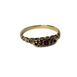 A VICTORIAN YELLOW METAL, RUBY AND DIAMOND RING Three graduated round cut rubies,interspersed with