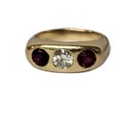 A 14CT GOLD, DIAMOND AND RUBY THREE STONE RING The central round cut diamond flanked with rubies