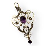 AN ART NOUVEAU 9CT GOLD, AMETHYST AND SEED PEARL PENDANT Central oval cut amethyst in a pierced