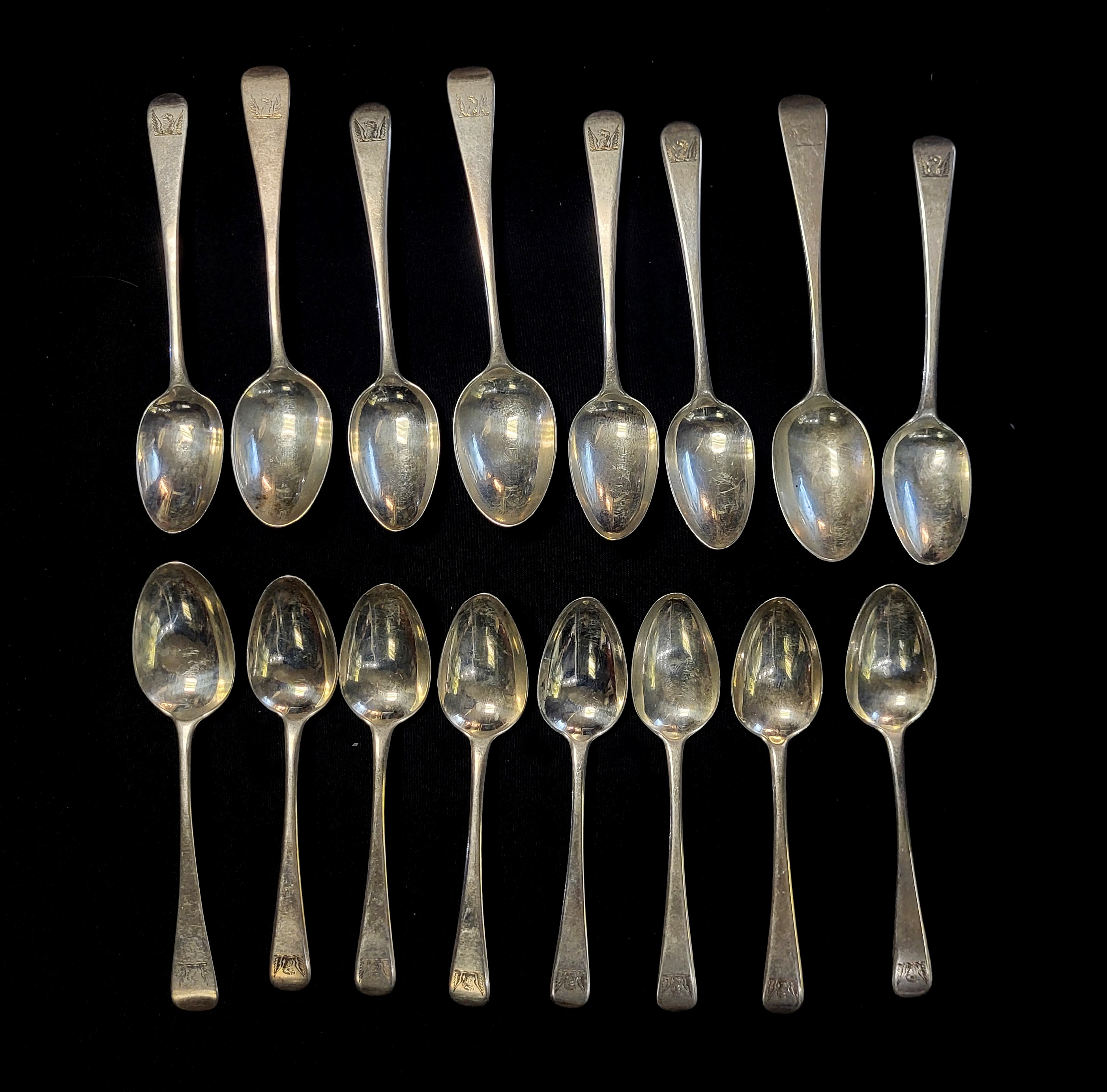 A MATCHED SET OF SIXTEEN GEORGIAN SILVER TEASPOONS Plain form, with engraved family crest of an