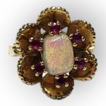 A VINTAGE 18CT GOLD, OPAL AND RUBY RING The central cabochon cut oval opal edged with round cut
