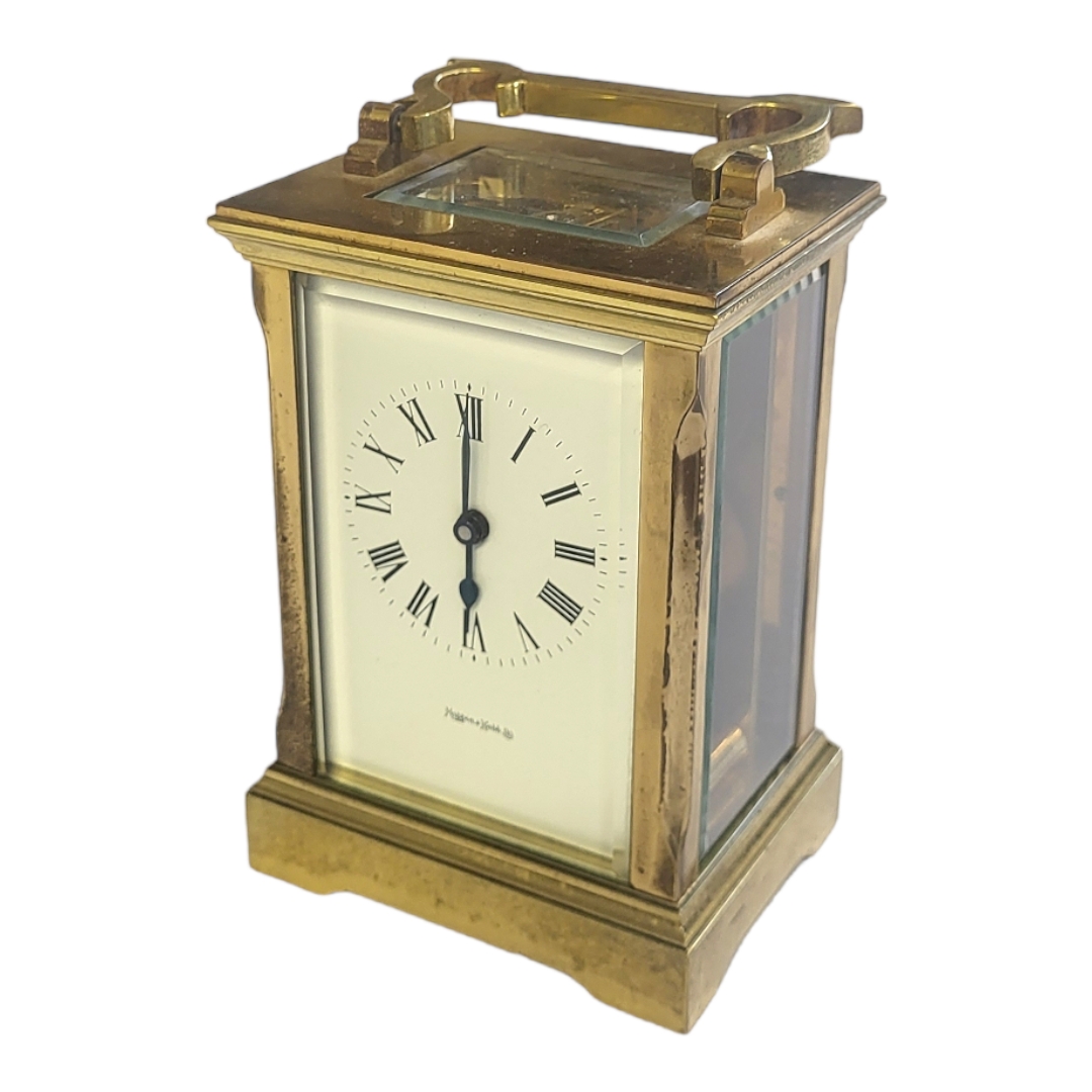 MAPPIN AND WEBB, A 20TH CENTURY GILT BRASS CARRIAGE CLOCK Having a single carry handle, white dial