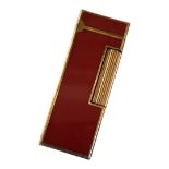 DUNHILL, A VINTAGE GOLD PLATE AND RED LACQUER CIGARETTE LIGHTER Rectangular form with flip lid,