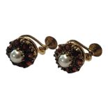 A PAIR OF 9CT GOLD, GARNET AND PEARL EARRINGS The single pearl edged with garnets forming a daisy