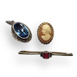 AN ART DECO 9CT GOLD AND GEM SET BROOCH The central baguette cut stone, together with 9ct gold cameo