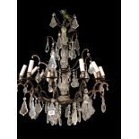 A LARGE IRON TWELVE BRANCH CHANDELIER Hung with numerous cut glass prisms. (drop 89cm) Condition: