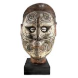 PAPUA NEW GUINEA, OCEANIA INTEREST. A CARVED WOOD TRIBAL HEAD MOUNTED ON BLACK STONE BASE Face being