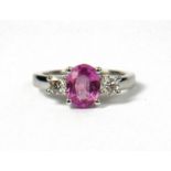 AN 18CT WHITE GOLD, OVAL PINK SAPPHIRE AND DIAMOND THREE STONE RING. (Approx Pink sapphire 1.50ct,